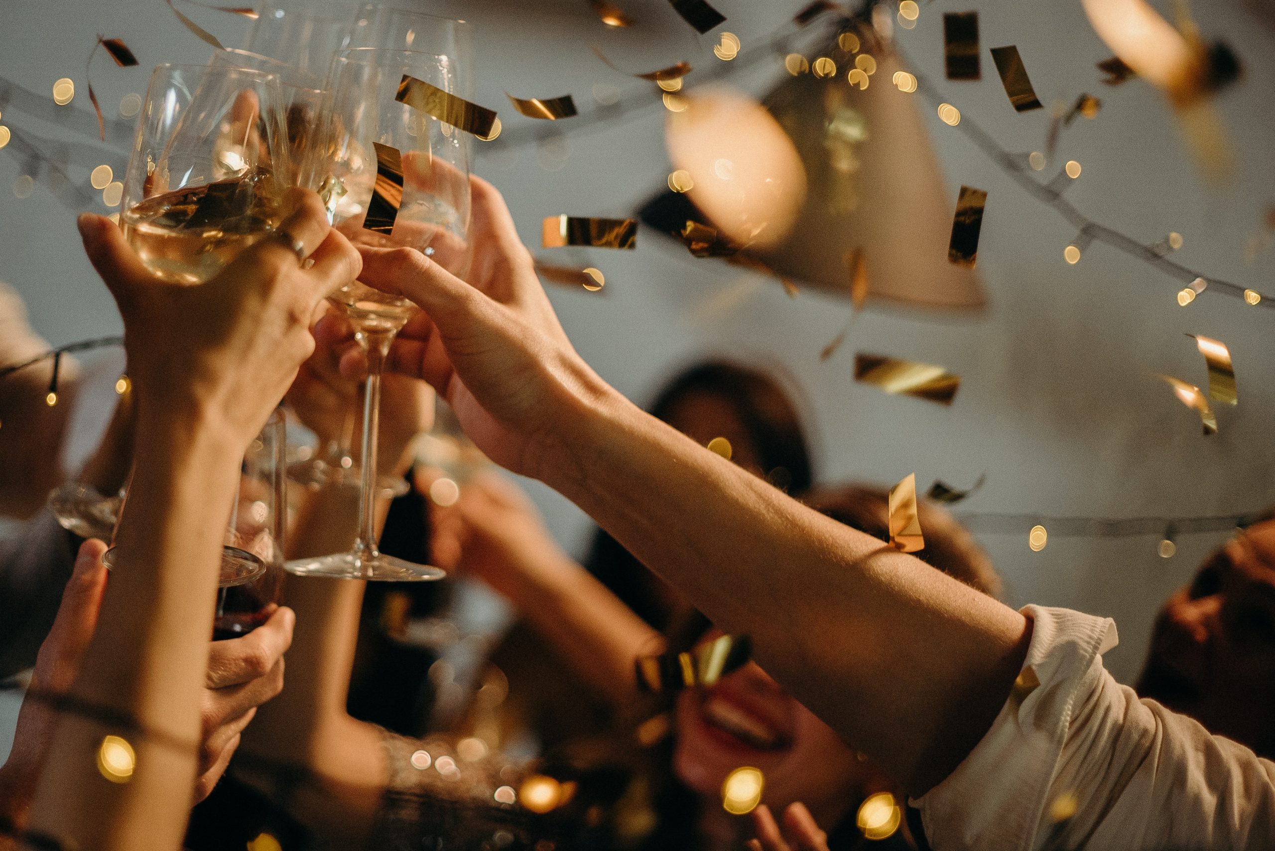 people raising glasses in a toast