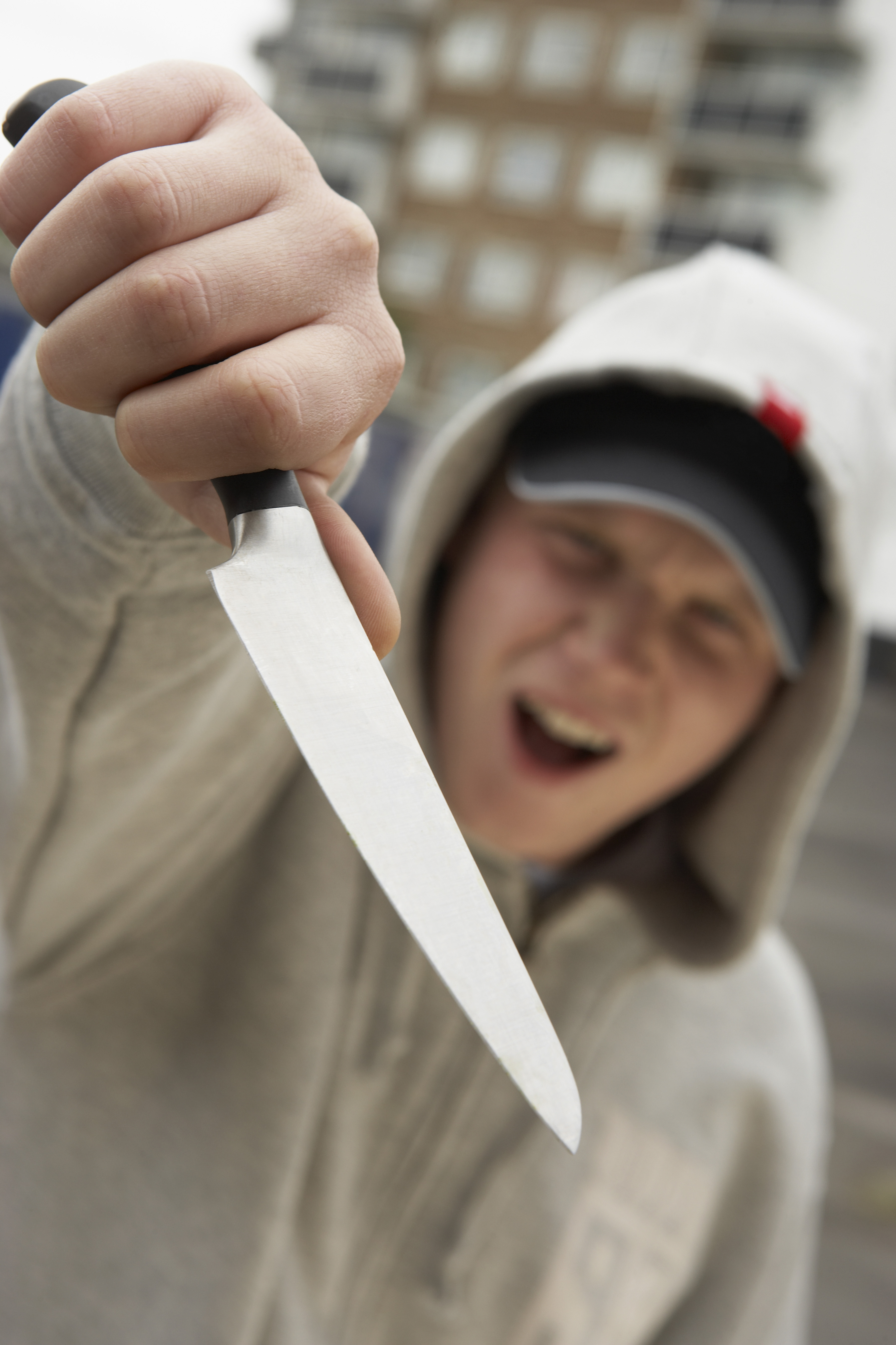 white youth holding knife in threatening way